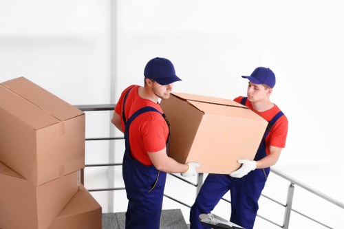 Furniture pick-up team removing a sofa in Bayswater