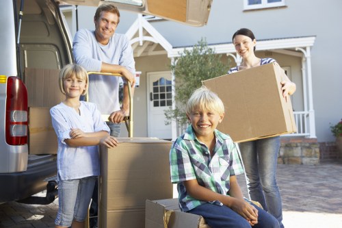 Trained removals staff handling boxes and furniture with care